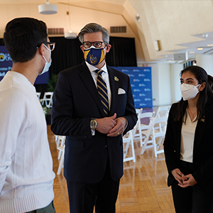 Daniel J. Allen, Ph.D. speaking with two students.
